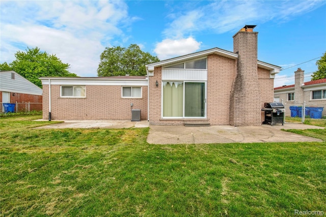 30232 Austin Dr, Warren, MI 48092 - back of property with a chimney, brick siding, and a patio area