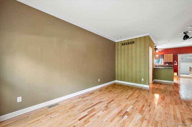366 Marshall St, Ferndale, MI 48220 - spare room featuring light wood finished floors, ornamental molding, wallpapered walls, and ceiling fan