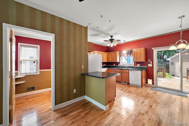 366 Marshall St, Ferndale, MI 48220 - kitchen featuring white appliances, dark countertops, light wood-style floors, wallpapered walls, and a peninsula