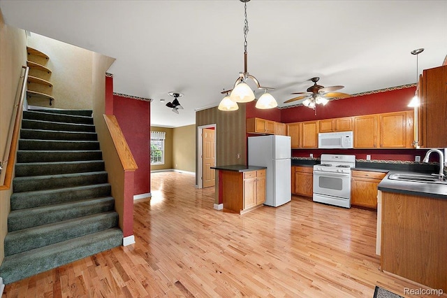 366 Marshall St, Ferndale, MI 48220 - kitchen featuring white appliances, dark countertops, ceiling fan, and light wood finished floors