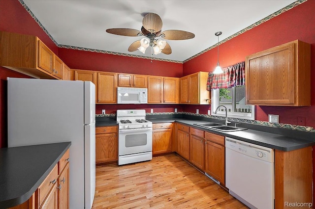 366 Marshall St, Ferndale, MI 48220 - kitchen featuring white appliances, dark countertops, light wood-type flooring, ceiling fan, and decorative light fixtures