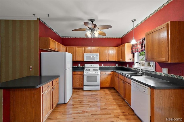 366 Marshall St, Ferndale, MI 48220 - kitchen with white appliances, dark countertops, light wood-type flooring, ceiling fan, and brown cabinets