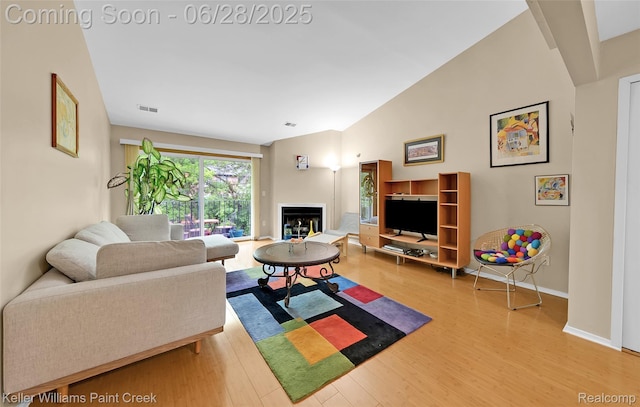 31514 Orchard Crk, Farmington Hills, MI 48334 - living room with wood finished floors, vaulted ceiling, and a fireplace