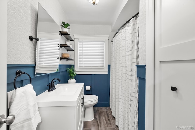 1609 Catalpa Dr, Berkley, MI 48072 - full bath with vanity, wood finished floors, and a wainscoted wall