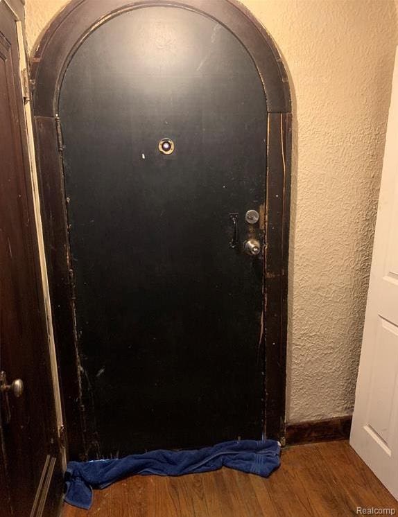 15100 Lesure St, Detroit, MI 48227 - detailed view of wood finished floors, heating fuel, a textured wall, and arched walkways