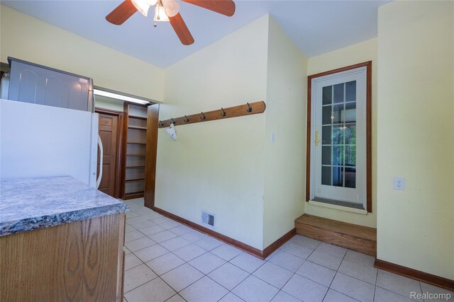 21128 Middlebelt Rd, New Boston, MI 48164 - kitchen with freestanding refrigerator, light tile patterned floors, and a ceiling fan