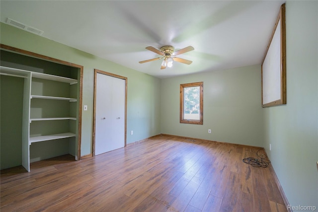 21128 Middlebelt Rd, New Boston, MI 48164 - unfurnished bedroom featuring wood finished floors and ceiling fan