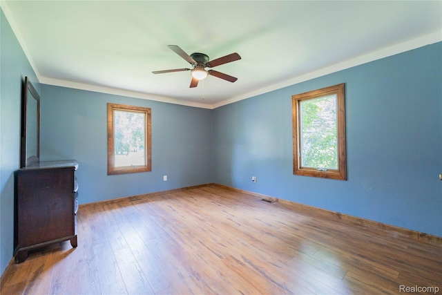 21128 Middlebelt Rd, New Boston, MI 48164 - unfurnished room featuring a ceiling fan, wood finished floors, and crown molding
