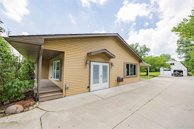 21128 Middlebelt Rd, New Boston, MI 48164 - rear view of house featuring french doors and an outdoor structure