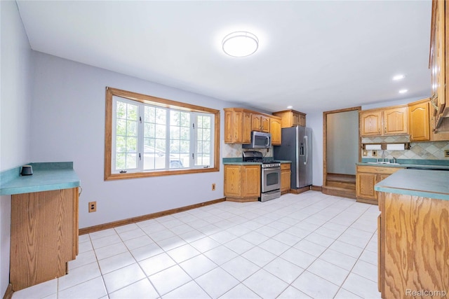 21128 Middlebelt Rd, New Boston, MI 48164 - kitchen with stainless steel appliances, tasteful backsplash, light tile patterned floors, light countertops, and recessed lighting