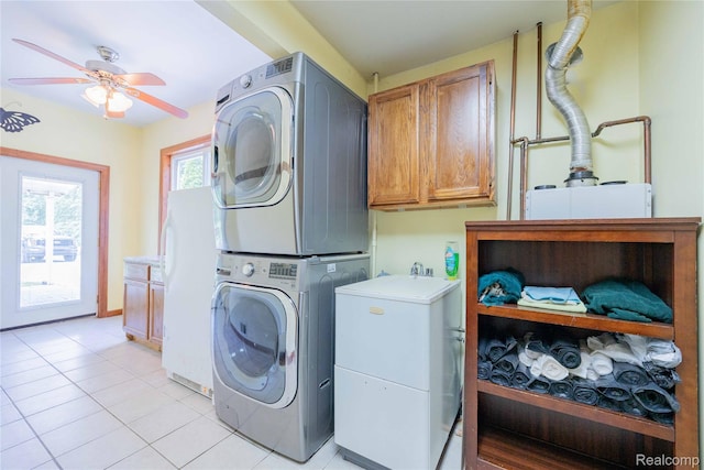 21128 Middlebelt Rd, New Boston, MI 48164 - laundry area featuring cabinet space, stacked washer and clothes dryer, a ceiling fan, and light tile patterned floors
