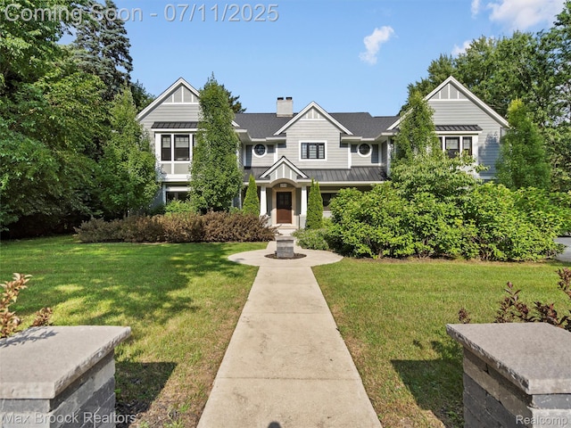 295 S Cranbrook Rd, Birmingham, MI 48009 - craftsman house featuring a standing seam roof, a metal roof, a front yard, and a chimney