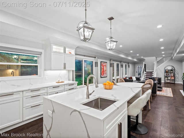 295 S Cranbrook Rd, Birmingham, MI 48009 - kitchen with open floor plan, recessed lighting, white cabinetry, light stone counters, and dark wood-style flooring