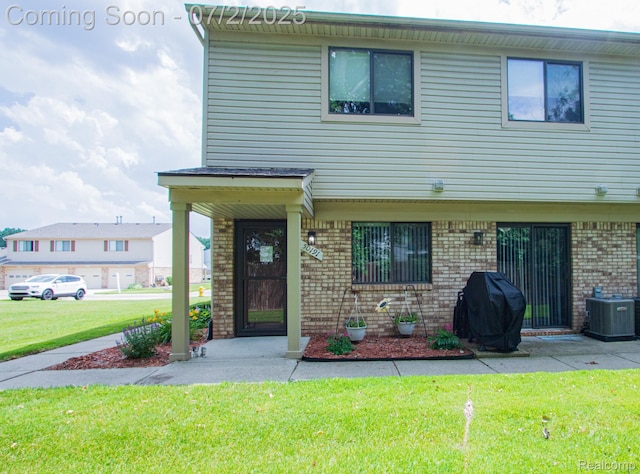 50191 N Angelo Ct, Chesterfield, MI 48047 - view of property featuring brick siding and a front lawn