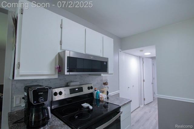 50191 N Angelo Ct, Chesterfield, MI 48047 - kitchen featuring appliances with stainless steel finishes, tasteful backsplash, white cabinetry, and light wood finished floors