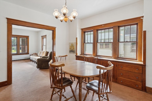 418 Main St, Battle Creek, MI 49014 - dining area with light colored carpet, a chandelier, and a baseboard radiator