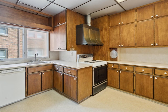 418 Main St, Battle Creek, MI 49014 - kitchen featuring white appliances, wall chimney range hood, brown cabinetry, and light countertops