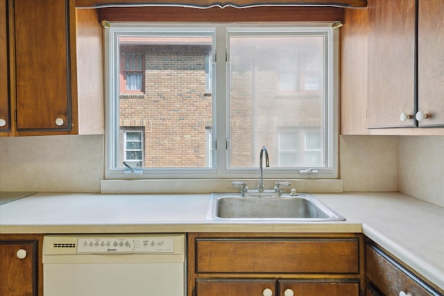 418 Main St, Battle Creek, MI 49014 - kitchen with dishwasher, light countertops, and brown cabinets