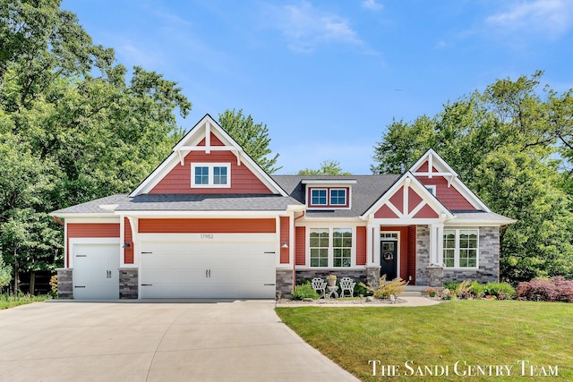 17952 Spring Tree Ct, Spring Lake, MI 49456 - craftsman inspired home featuring stone siding, a garage, a front lawn, and driveway