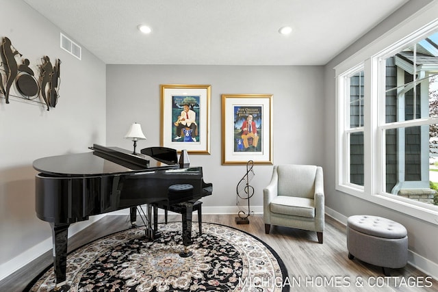 4401 Grand Pt, Holland, MI 49424 - sitting room with wood finished floors and recessed lighting