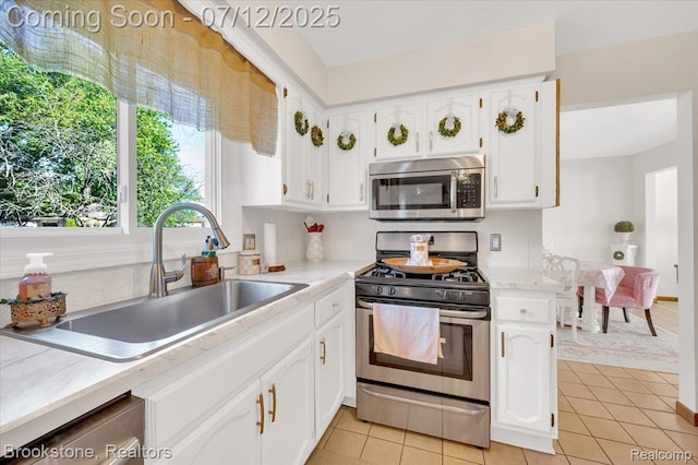 46655 Spruce Dr, Shelby Twp, MI 48315 - kitchen featuring stainless steel appliances, white cabinets, tasteful backsplash, and light tile patterned floors