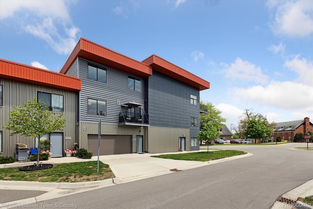 293 N 2nd St Unit 106, Brighton, MI 48116 - view of building exterior featuring concrete driveway and an attached garage
