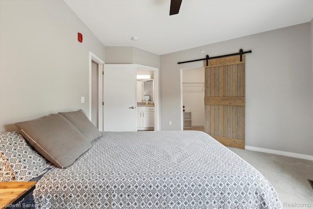 293 N 2nd St Unit 106, Brighton, MI 48116 - bedroom with a barn door, carpet flooring, a walk in closet, a closet, and a ceiling fan