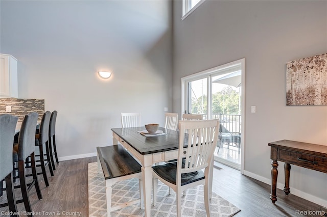 293 N 2nd St Unit 106, Brighton, MI 48116 - dining area featuring healthy amount of natural light, a high ceiling, and wood finished floors