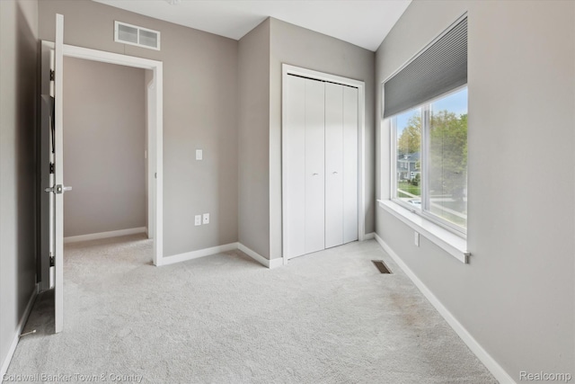 293 N 2nd St Unit 106, Brighton, MI 48116 - unfurnished bedroom featuring carpet floors and a closet