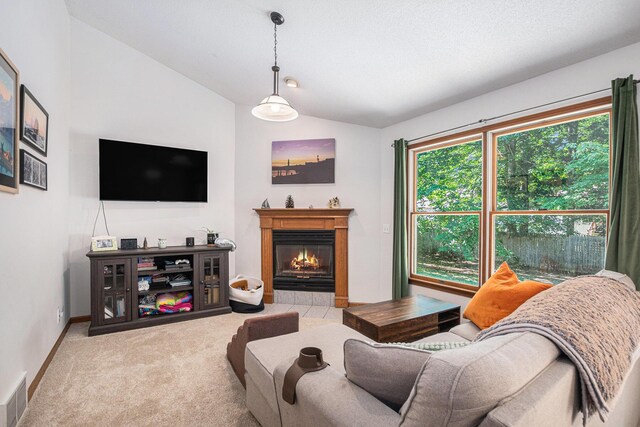 15303 Arborwood Dr, Grand Haven, MI 49417 - living area with lofted ceiling, carpet flooring, and a tile fireplace