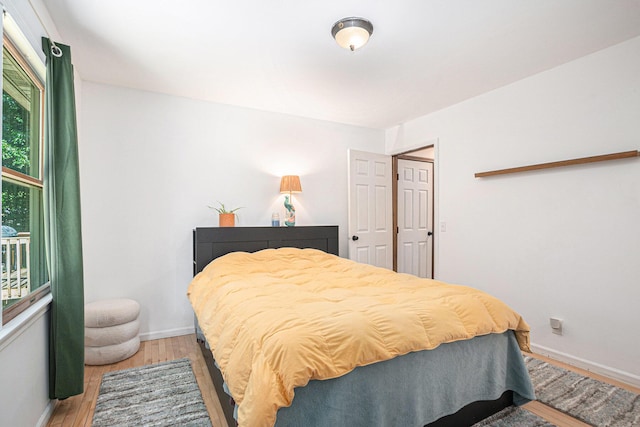 15303 Arborwood Dr, Grand Haven, MI 49417 - bedroom featuring light wood-style flooring and baseboards
