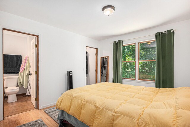 15303 Arborwood Dr, Grand Haven, MI 49417 - bedroom with light wood-style flooring and ensuite bath