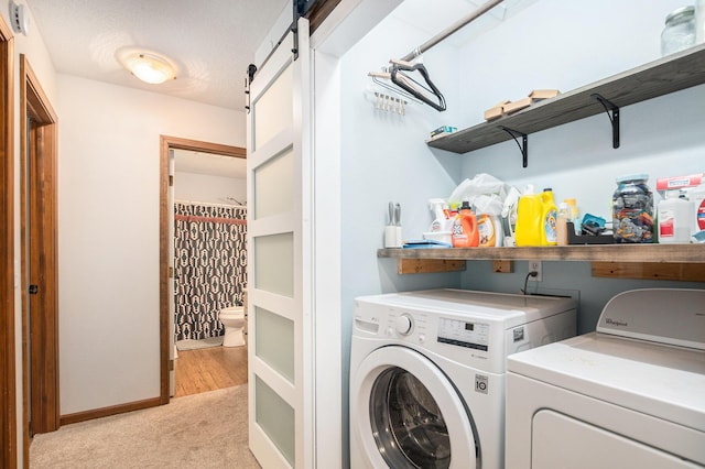 15303 Arborwood Dr, Grand Haven, MI 49417 - washroom with separate washer and dryer, light colored carpet, and a barn door