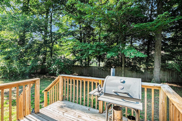 15303 Arborwood Dr, Grand Haven, MI 49417 - wooden terrace with a fenced backyard and area for grilling