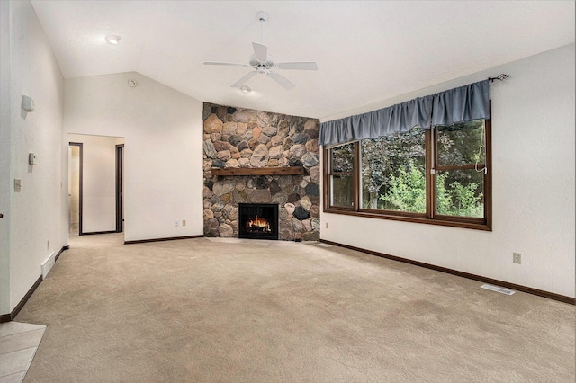 9477 Lightwood Ct, Richland, MI 49083 - unfurnished living room with lofted ceiling, carpet floors, ceiling fan, and a stone fireplace
