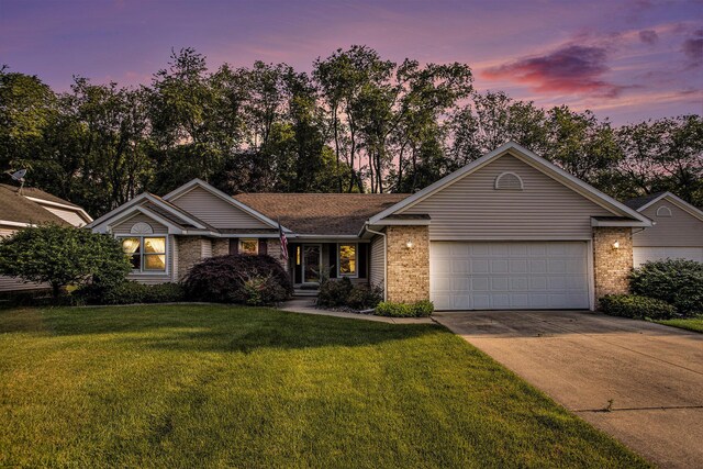 9477 Lightwood Ct, Richland, MI 49083 - ranch-style home with brick siding, driveway, an attached garage, and a lawn