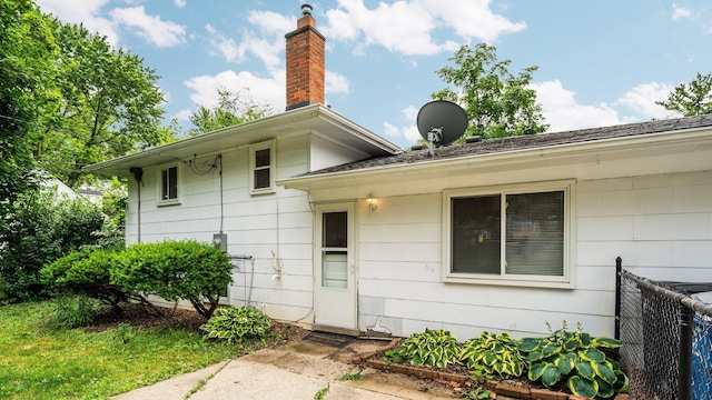 2204 Walter Dr, Ann Arbor, MI 48103 - view of exterior entry featuring a chimney