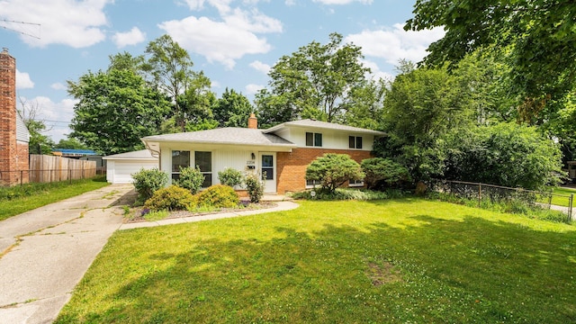2204 Walter Dr, Ann Arbor, MI 48103 - split level home featuring brick siding, a detached garage, and a chimney