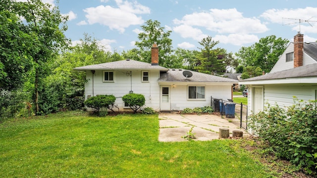 2204 Walter Dr, Ann Arbor, MI 48103 - back of house featuring a patio area, a chimney, and roof with shingles