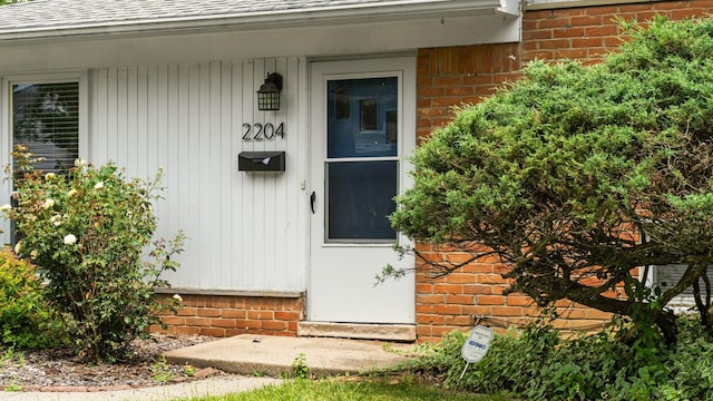 2204 Walter Dr, Ann Arbor, MI 48103 - entrance to property featuring roof with shingles and brick siding