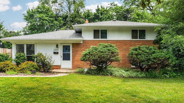 2204 Walter Dr, Ann Arbor, MI 48103 - view of front of house featuring brick siding, a front yard, and a shingled roof
