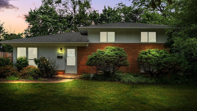 2204 Walter Dr, Ann Arbor, MI 48103 - view of front of house featuring brick siding, a lawn, and roof with shingles