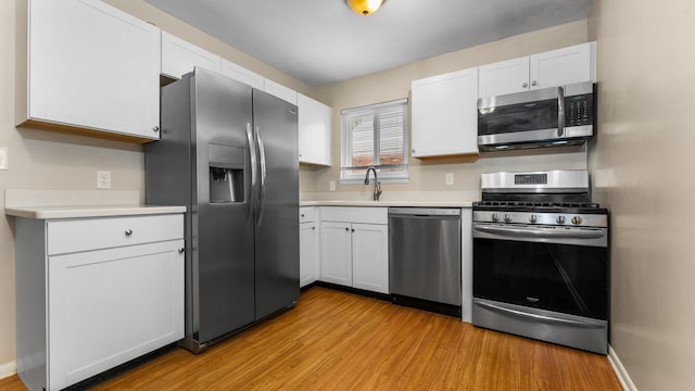 2204 Walter Dr, Ann Arbor, MI 48103 - kitchen with appliances with stainless steel finishes, light wood-type flooring, and light countertops