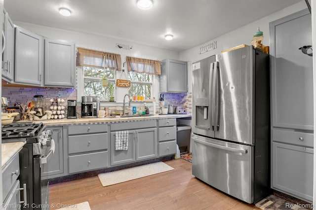 25021 Ecorse Rd, Taylor, MI 48180 - kitchen featuring stainless steel appliances, gray cabinets, backsplash, and light countertops