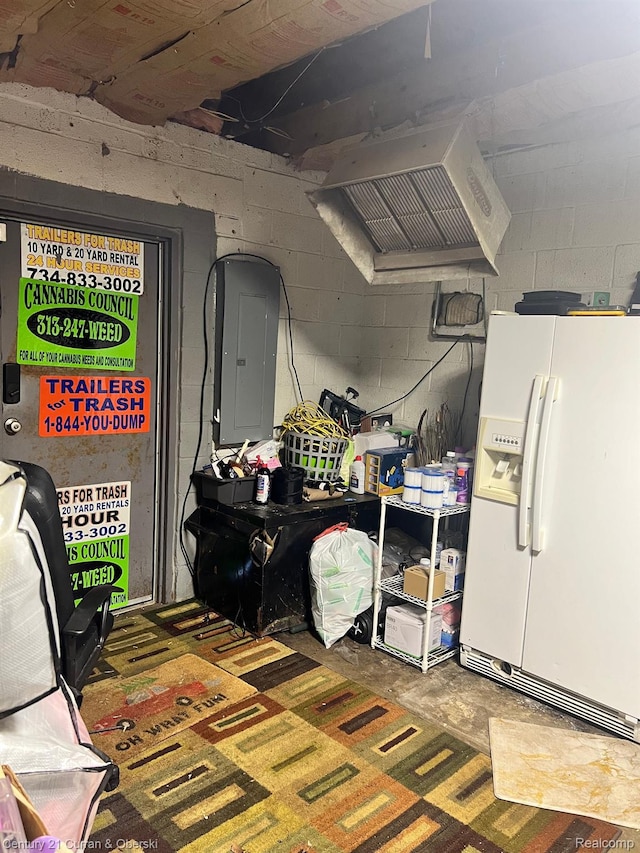 25021 Ecorse Rd, Taylor, MI 48180 - kitchen featuring white refrigerator with ice dispenser, electric panel, extractor fan, and concrete block wall