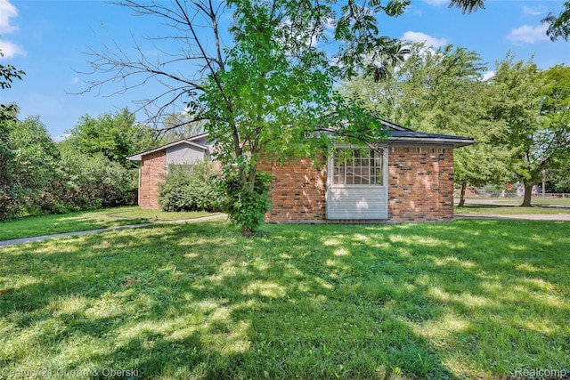 5620 Kaufman St, Dearborn Heights, MI 48125 - view of property exterior featuring a yard and brick siding