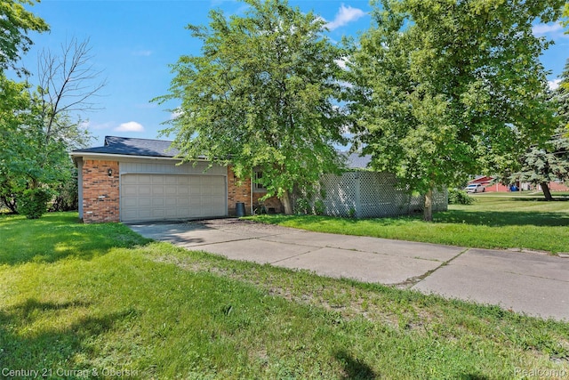 5620 Kaufman St, Dearborn Heights, MI 48125 - view of front facade featuring brick siding, a front lawn, concrete driveway, and a garage