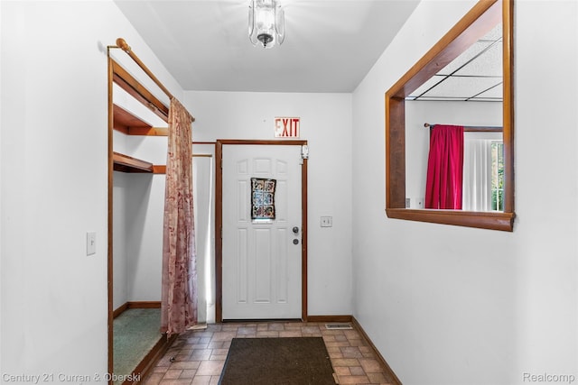 5620 Kaufman St, Dearborn Heights, MI 48125 - doorway featuring stone finish flooring and baseboards