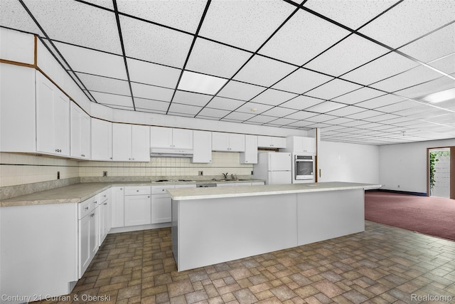 5620 Kaufman St, Dearborn Heights, MI 48125 - kitchen with oven, freestanding refrigerator, cooktop, a center island, and light countertops