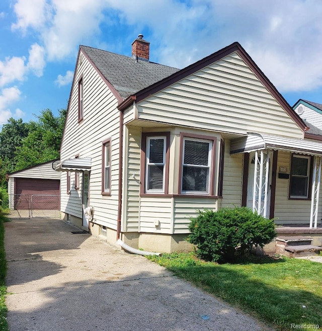 14535 Russell Ave, Allen Park, MI 48101 - bungalow featuring an outbuilding, a chimney, a garage, and roof with shingles